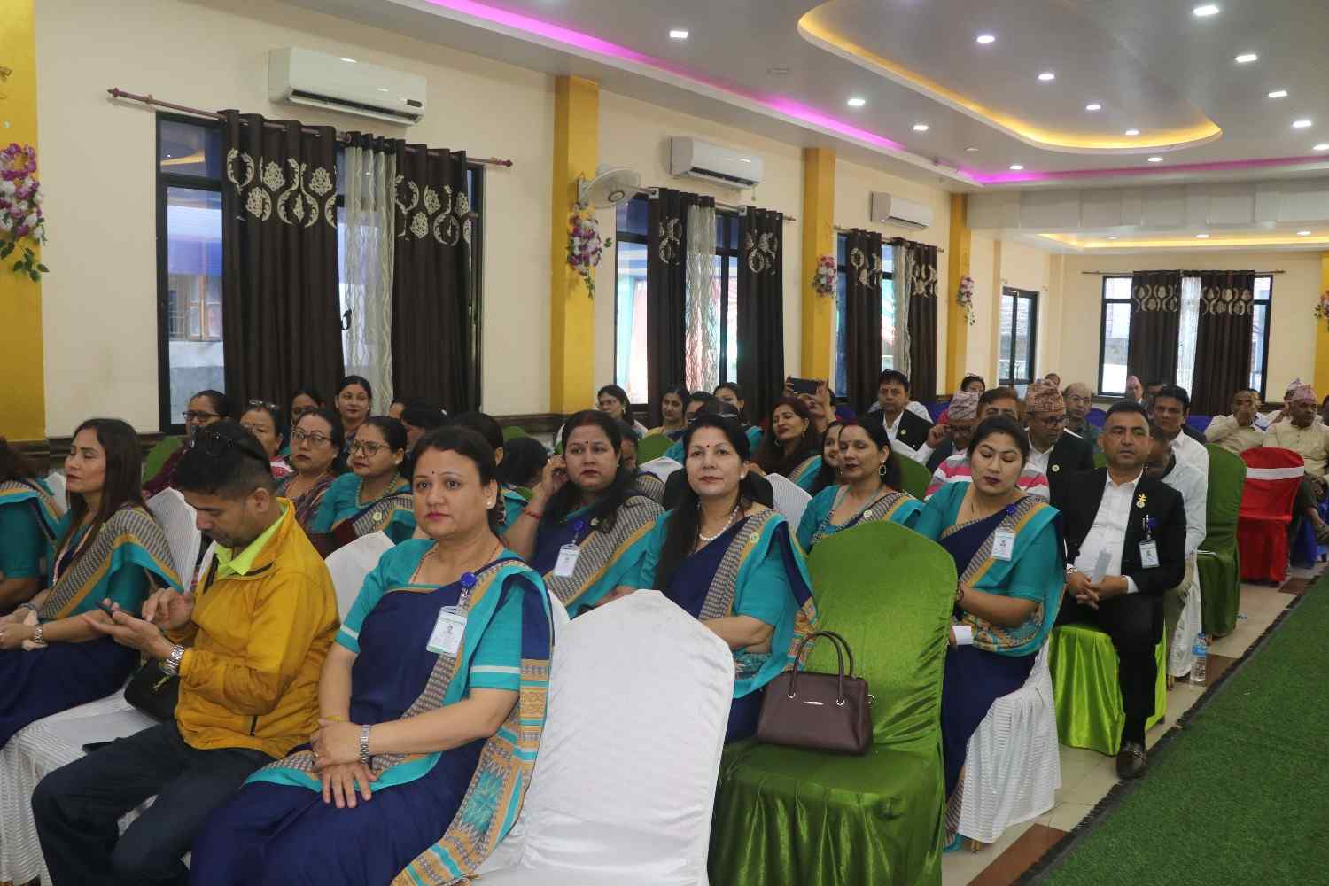 Female attendees in traditional attire at the ceremony